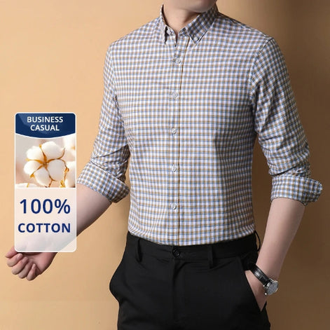 Person wearing a checkered shirt with a label indicating 100% cotton and business casual suitability.