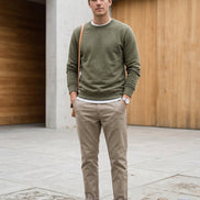 A pair of light beige chino pants shown flat against a solid white background.