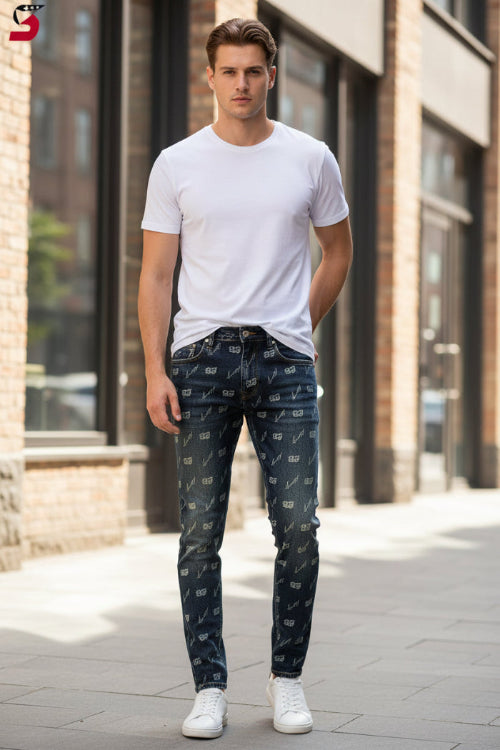 Dark wash denim jeans with an all-over repeating '93' monogram pattern, laid flat on a brown wooden plank 
