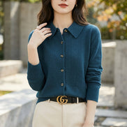 Woman wearing a blue cardigan with a blurred background