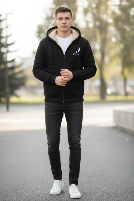 Black hoodie with beige lining on a textured beige background