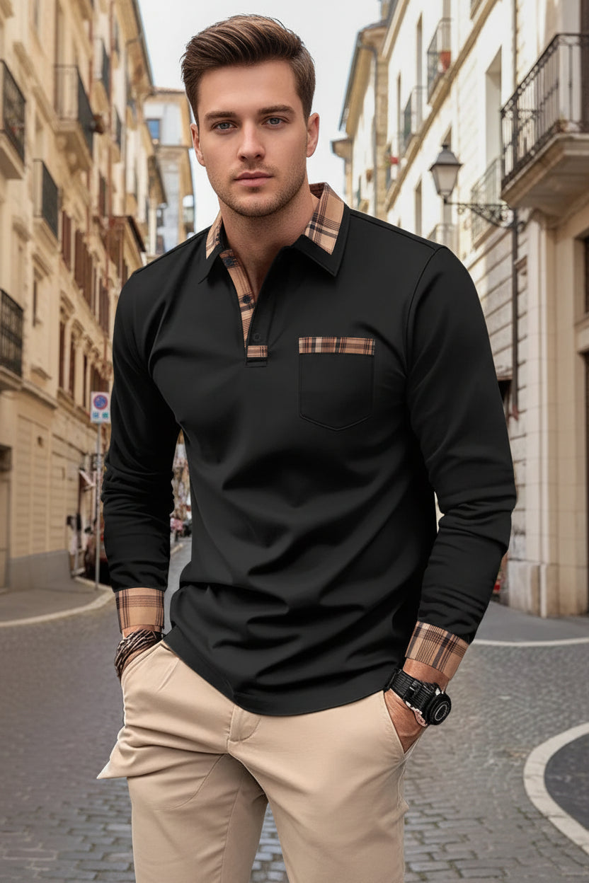Man wearing a black long-sleeve polo shirt with plaid accents on a city street.