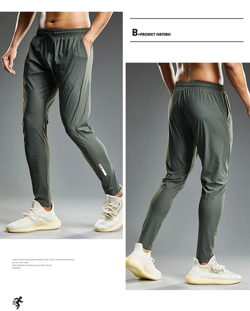 Green athletic pants worn by a person on a gray background