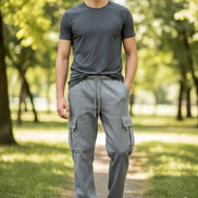 Person wearing gray cargo pants on a white background