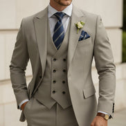 Beige suit with striped tie and pocket square on a white background