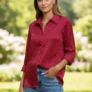 Red leopard print shirt worn by a person against a gray background