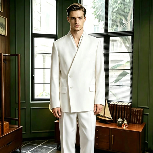 A man wearing a white double-breasted suit with a shawl collar stands in a vintage room with dark green walls and large windows.
