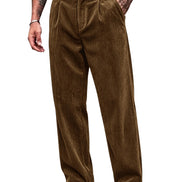 A person wearing brown corduroy trousers with a black belt, paired with black-and-white shoes, shown from the waist down on a plain white background.