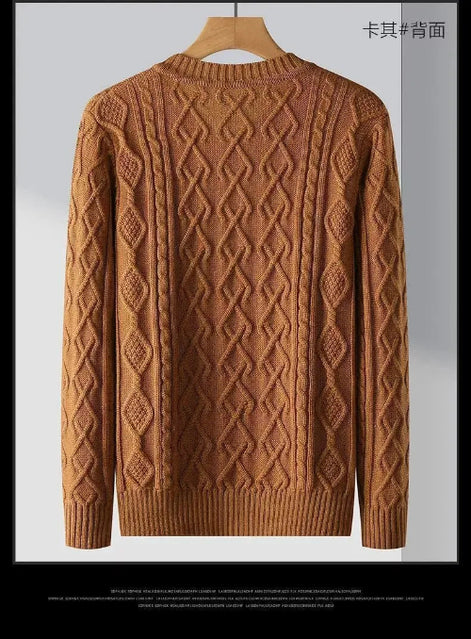 Brown sweater with intricate pattern on a hanger against a gray background