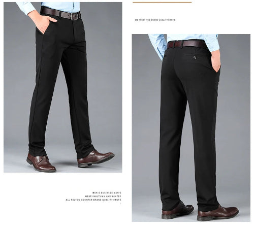 Black dress pants worn by a person on a gray background