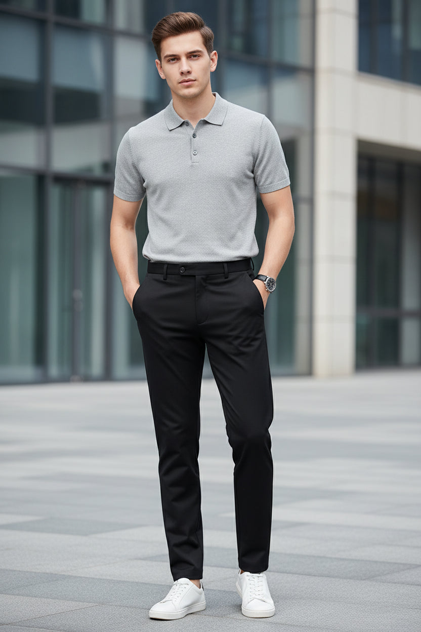 Black pants worn by a person on a gray background
