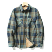 A long-sleeve plaid overshirt with a beige sherpa lining, displayed on a wooden hanger against a white background.