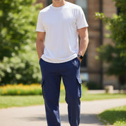 Person wearing navy cargo pants on a white background