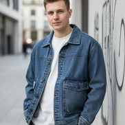 Blue denim jacket on a plain background