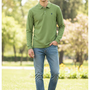 Green polo shirt on a hanger with other colored shirts in the background