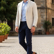 Brown crocodile-patterned loafers with gold accents on a white background