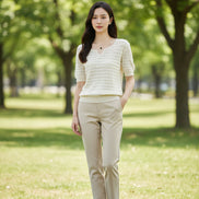 Woman wearing a white textured top with a blurred background
