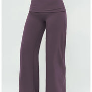 Purple yoga pants worn by a person on a white background
