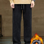 Person wearing black pants with a flame graphic in the corner