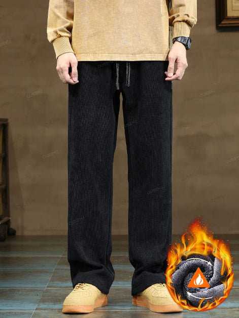 Person wearing black pants with a flame graphic in the corner