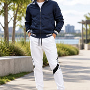 Navy jacket and white pants with black accents on a white background