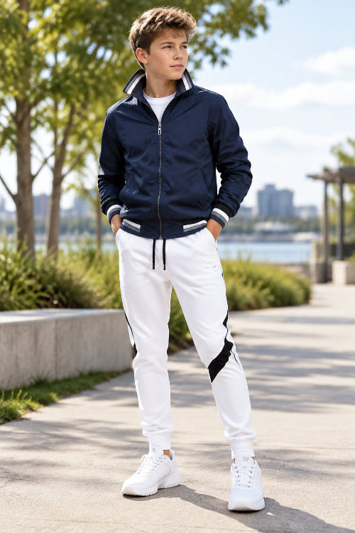 Navy jacket and white pants with black accents on a white background