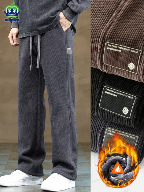 Gray sweatpants with a flame graphic and brand logo on a neutral background