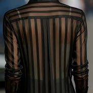 Black sheer striped shirt worn by a model, shown from the back.