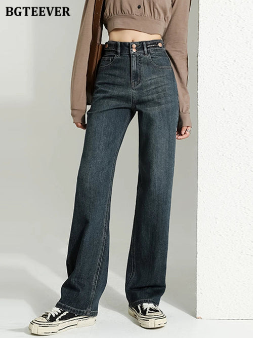 A model wearing a pair of high-waisted, wide-leg dark blue denim jeans from BGTEEVER, styled with a brown cropped 