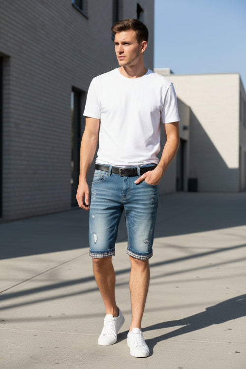 Blue denim shorts with plaid lining on a yellow background