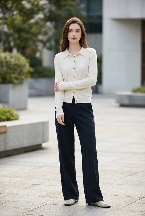 White long-sleeve shirt with buttons worn by a person, blurred background