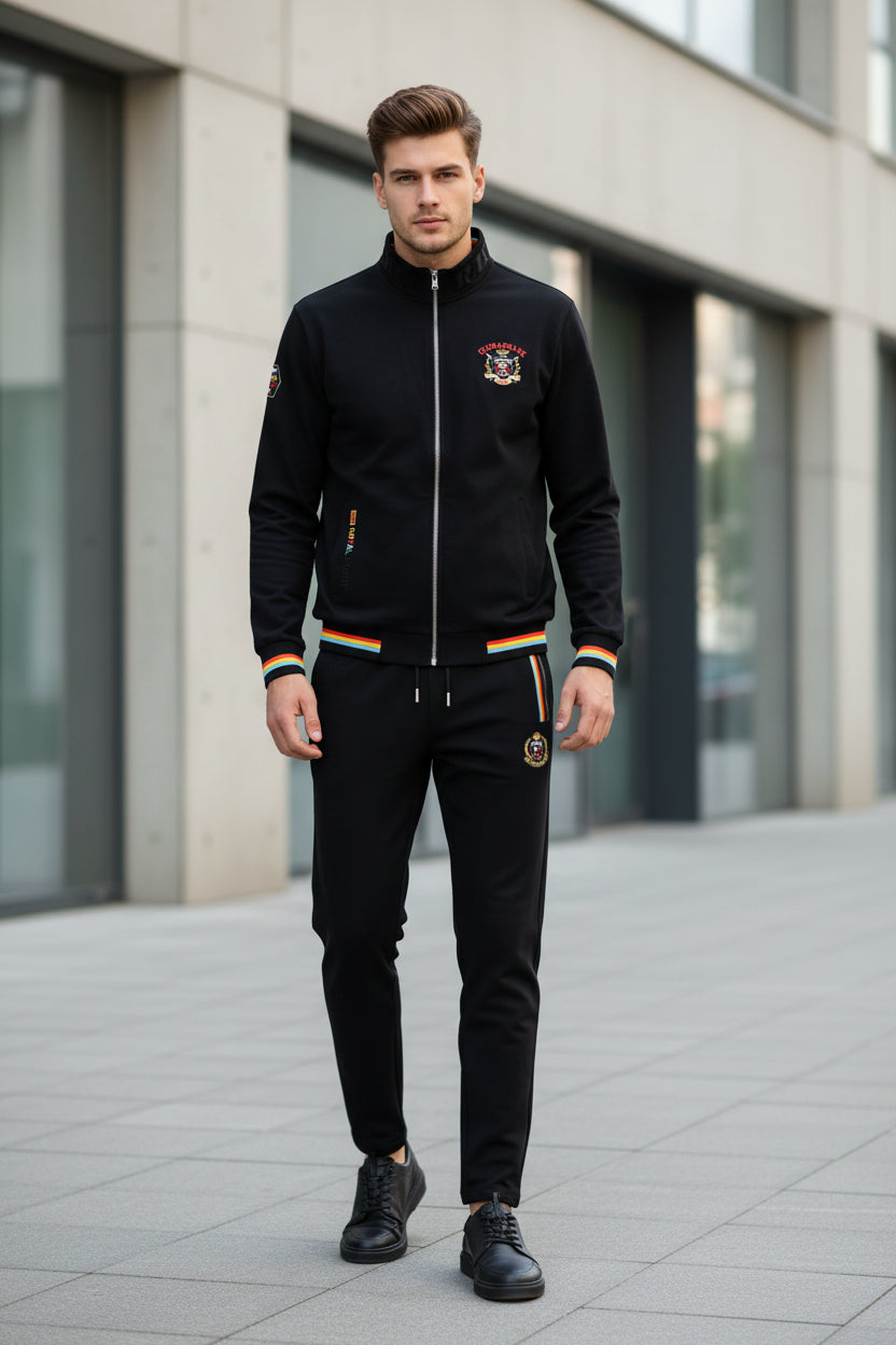 A two-piece navy blue tracksuit set featuring a zip-up jacket and matching pants. The jacket and pants have red, yellow, and white striped accents at the cuffs, hem, and waistband.