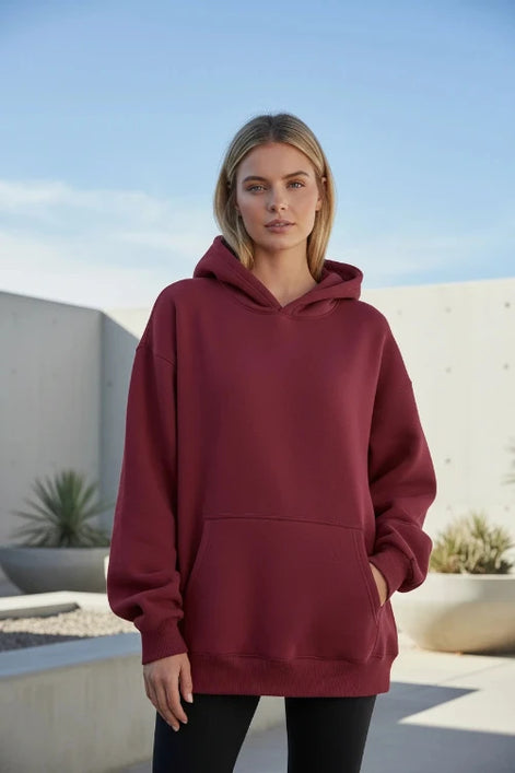 Maroon hoodie worn by a person on a white background