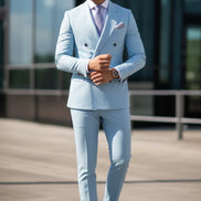 Light blue suit with a patterned tie and pocket square, worn by a person.