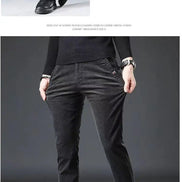 Black pants worn by a person on a gray background