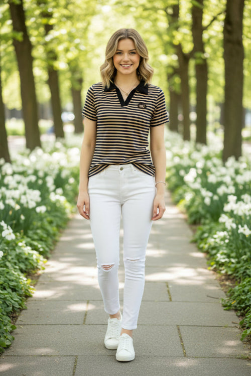 A close-up of a person wearing a short-sleeve polo shirt with navy blue and beige horizontal stripes, featuring a solid navy collar 