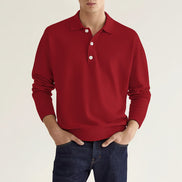 Red long-sleeve polo shirt worn by a person on a beige background