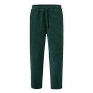 Green corduroy pants on a white background
