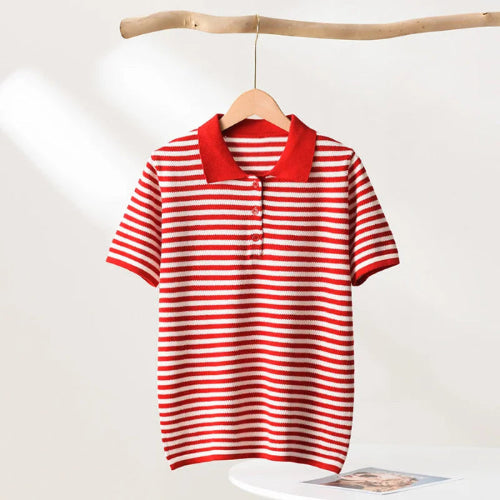 Red and white striped polo shirt on a wooden hanger against a white background