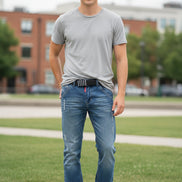 Pair of blue jeans with slight distressing on a white background