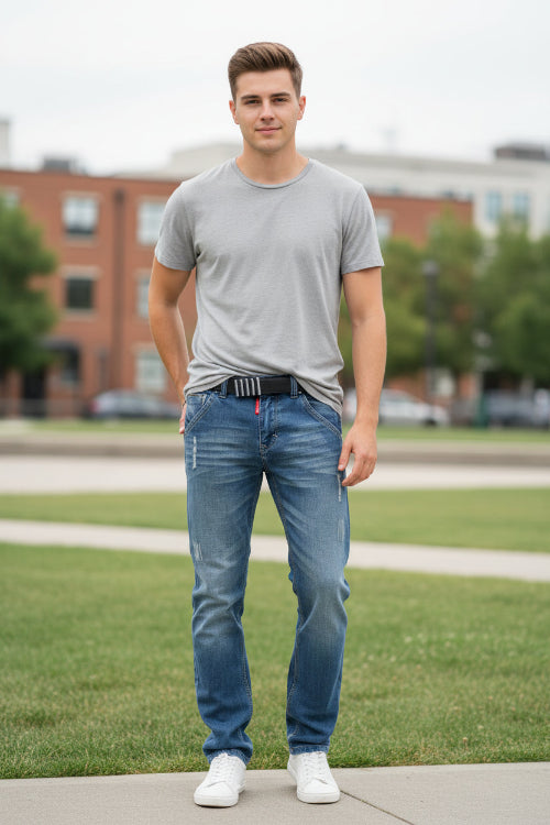 Pair of blue jeans with slight distressing on a white background