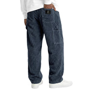 Blue corduroy pants worn by a person on a white background