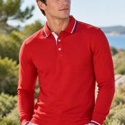 A red long-sleeve polo shirt with a white and blue striped collar and matching striped cuffs, shown on a plain white background.