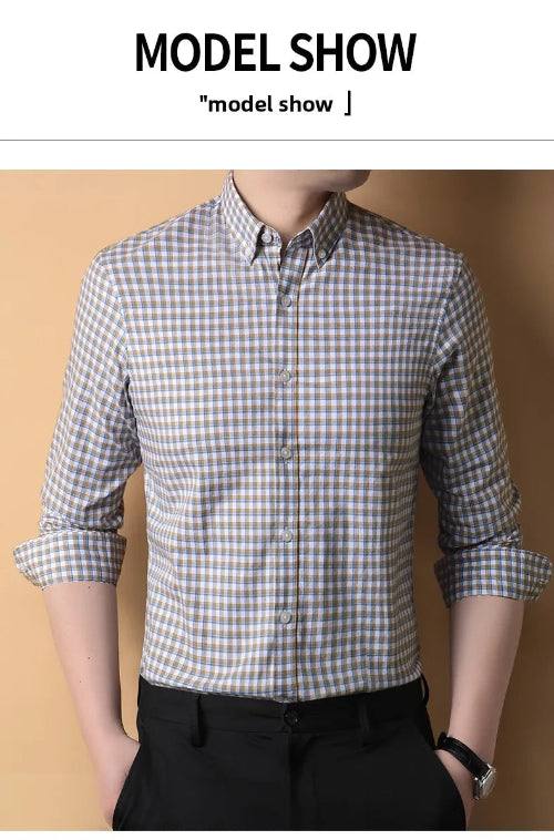 Person wearing a checkered shirt with rolled-up sleeves against a beige background