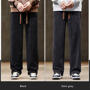 Two pairs of wide-leg pants, one black and one dark gray, worn by models against a neutral background.