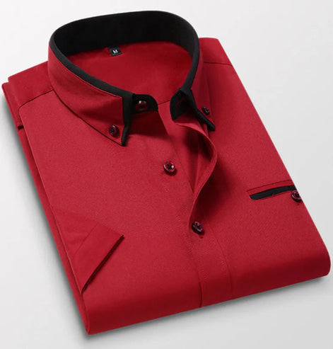 Folded red shirt with black trim on a light gray background