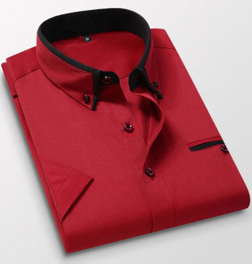 Folded red shirt with black trim on a light gray background