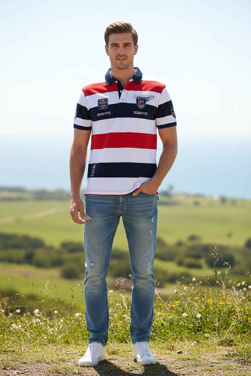 A short-sleeve striped polo shirt with horizontal bands of white, red, and navy blue. The shirt features a navy blue collar, a navy blue chest stripe, and multiple embroidered and printed patches on the chest and sleeves.