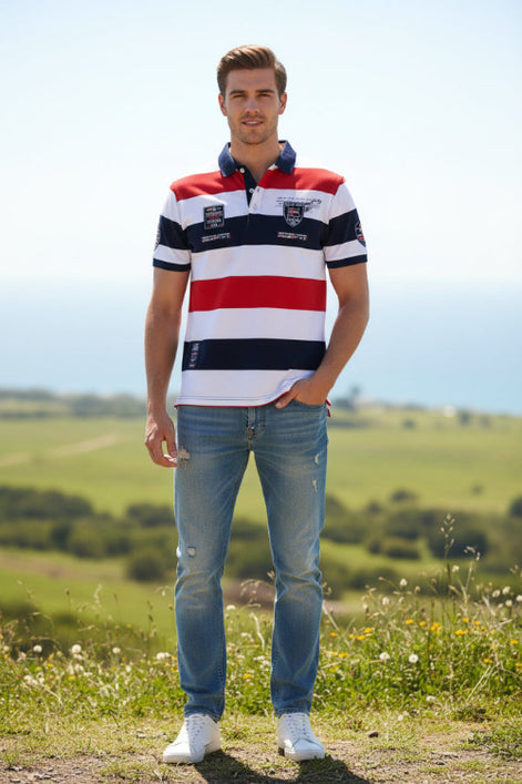A short-sleeve striped polo shirt with horizontal bands of white, red, and navy blue. The shirt features a navy blue collar, a navy blue chest stripe, and multiple embroidered and printed