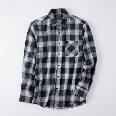 Plaid shirt on a hanger against a white background